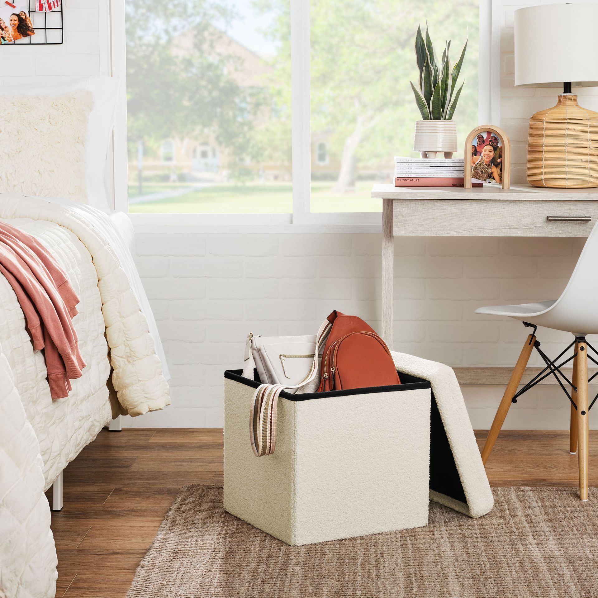 A white ottoman is sitting in a bedroom next to a bed and desk.