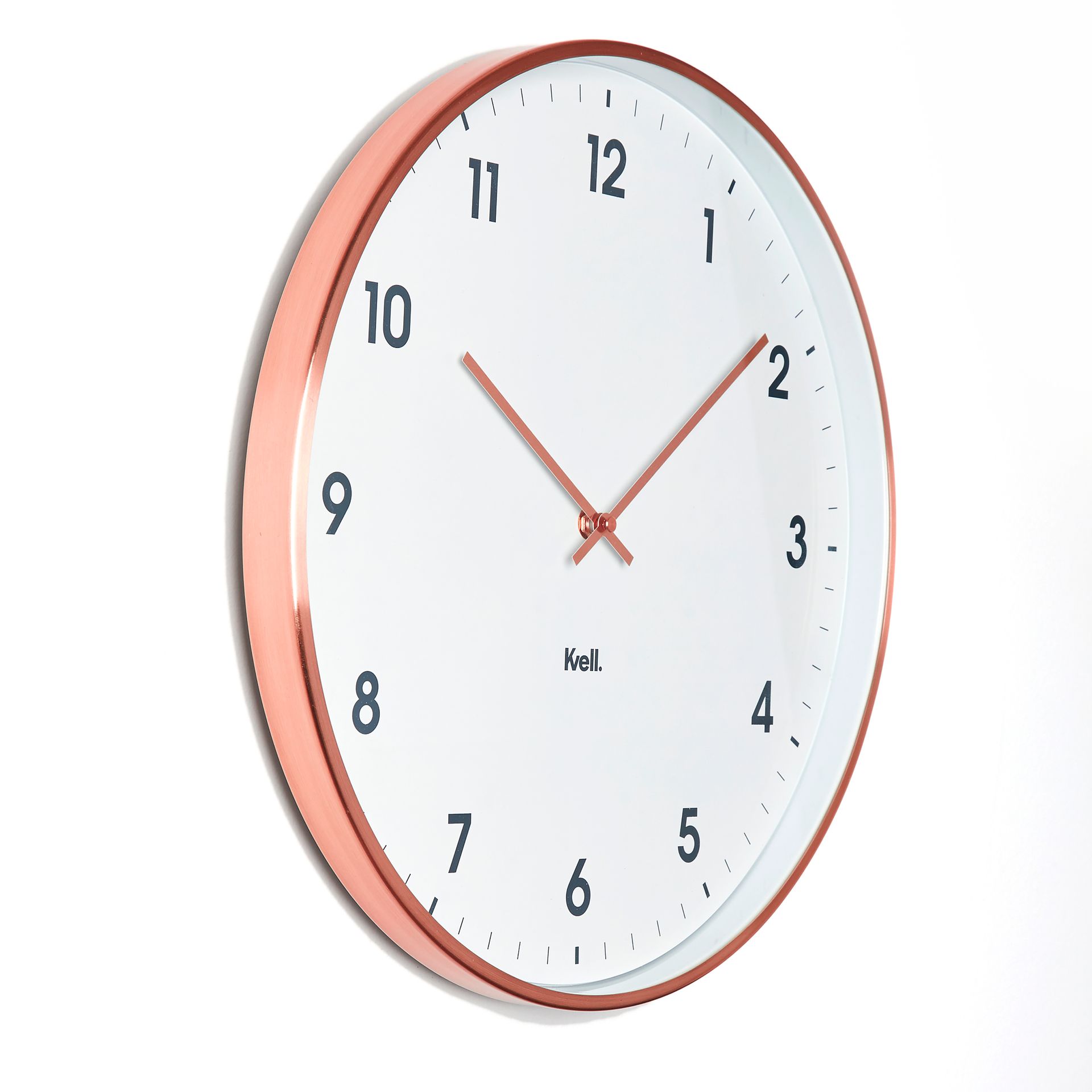 A white clock with a copper rim has the hands on the numbers 1 and 12