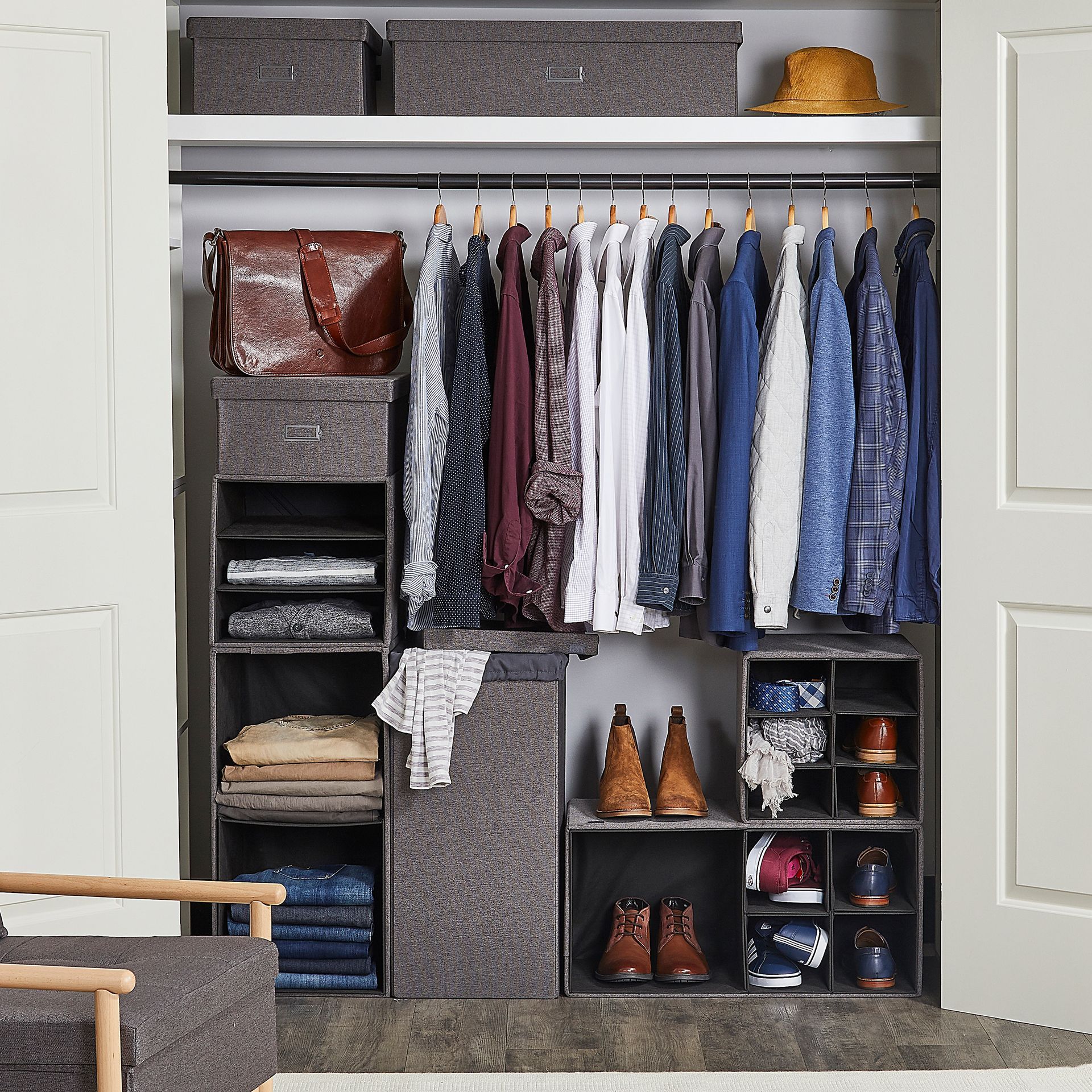 A closet filled with clothes and shoes and a chair