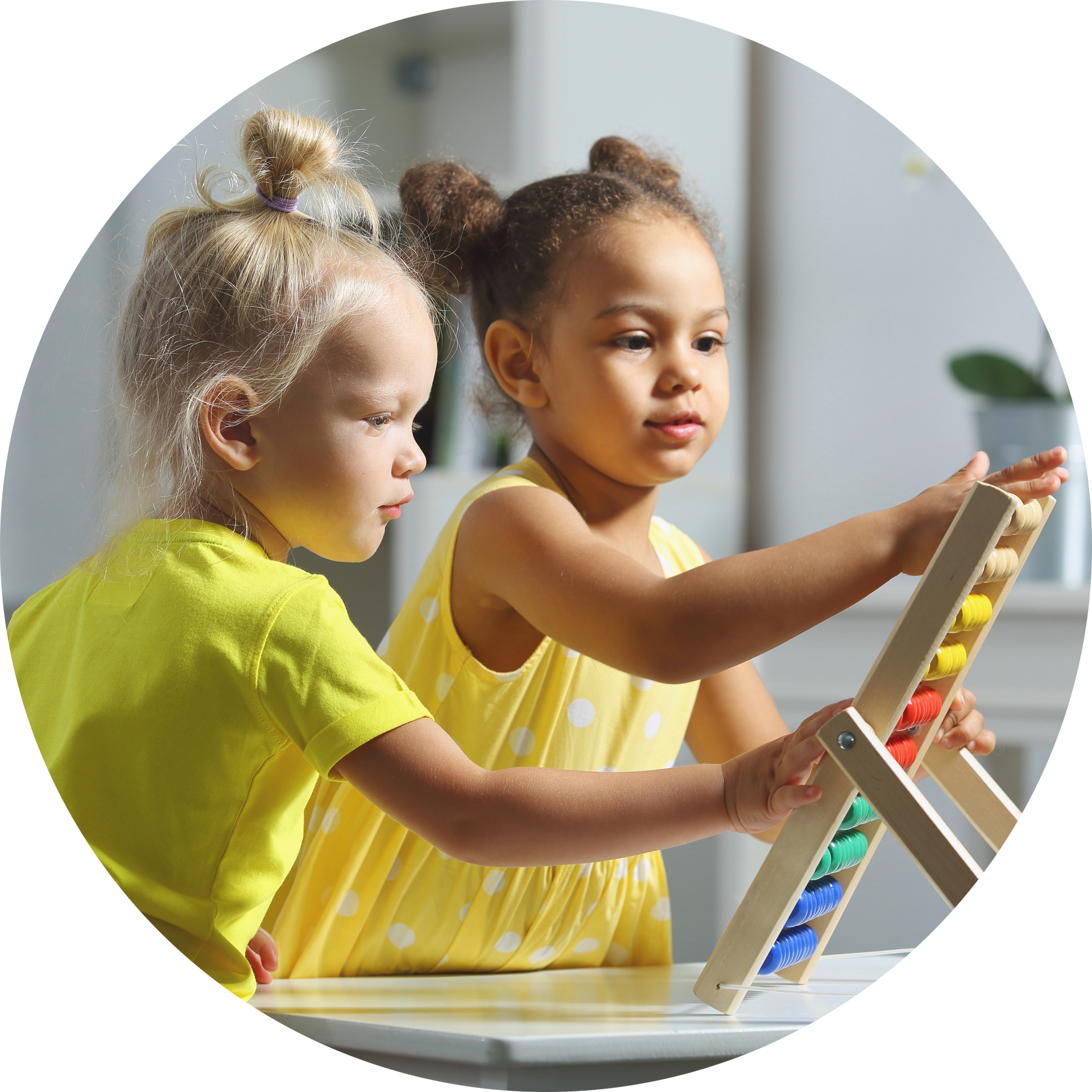 Two little girls are playing with a wooden abacus.