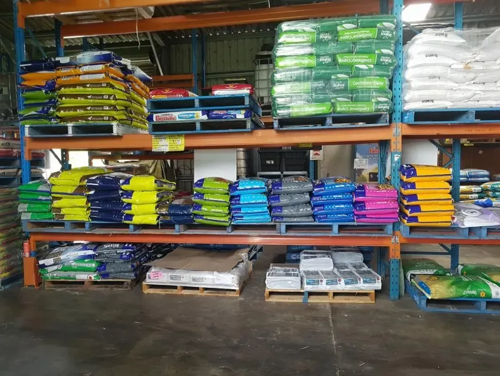 Shelves Stocked With Pallets of Bagged Feed in a Warehouse — NQ Stockfeeds & Farm Supplies In Mossman, QLD