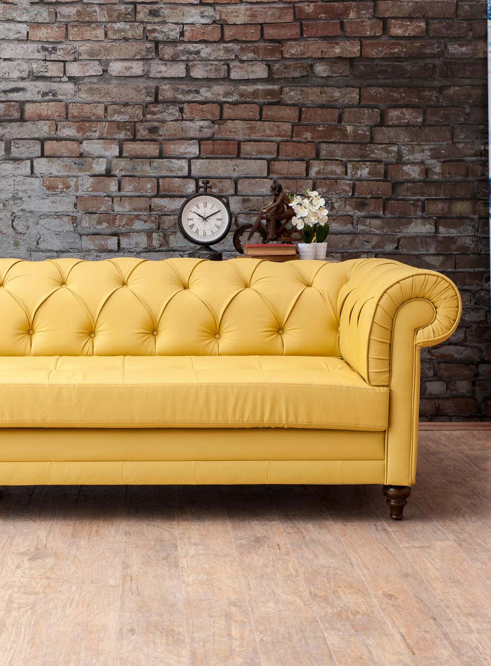 yellow sofa living room with brick wall