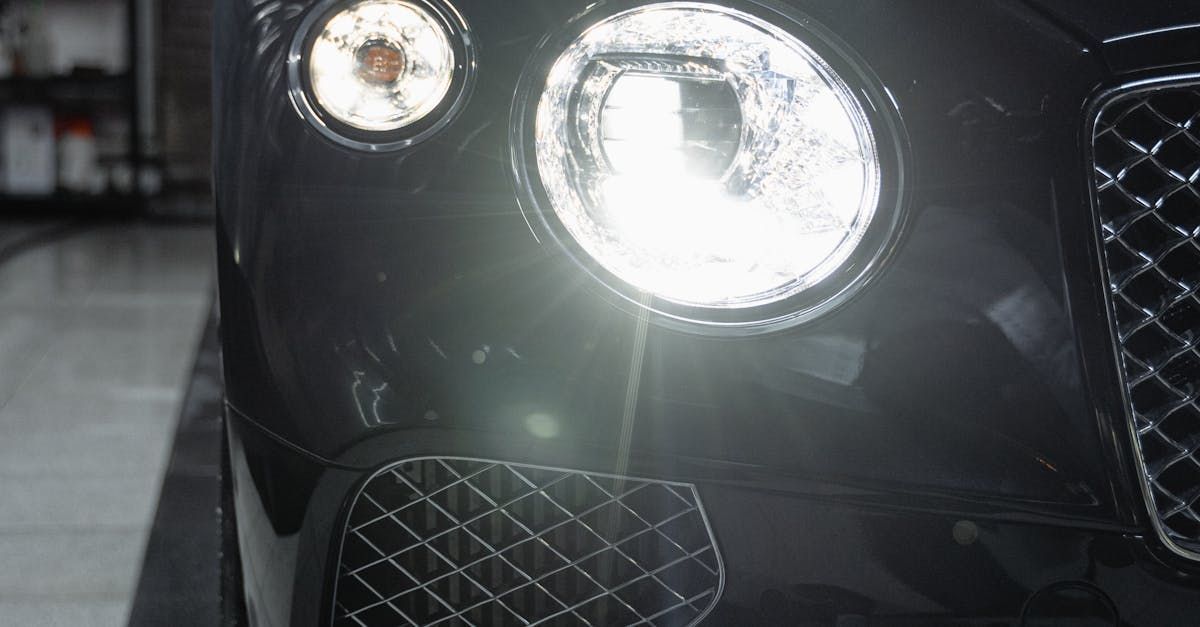 A close up of a bentley car 's headlights in a garage.  | Auto DR