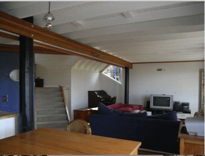 A Living Room With A Blue Couch And A Flat Screen TV — Yves De Wilde Quality Painting Services In Lismore, NSW