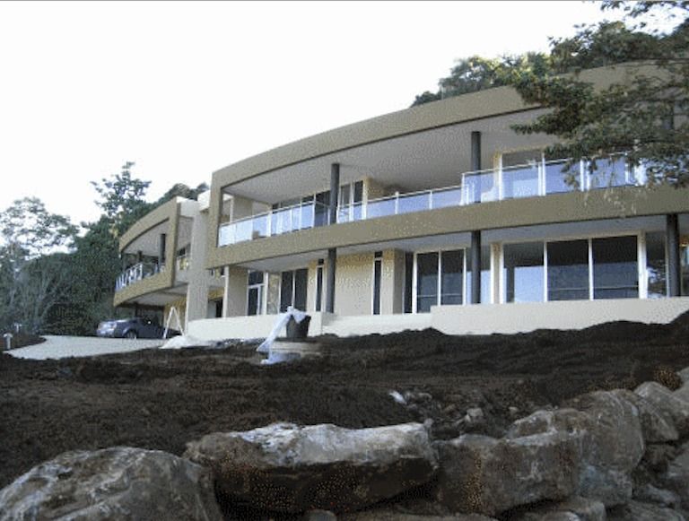 A Large House With A Lot Of Windows And A Lot Of Rocks In Front Of It — Yves De Wilde Quality Painting Services In Lismore, NSW