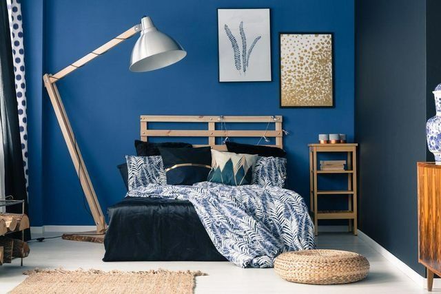 A Bedroom With Blue Walls, A Bed, A Lamp, And A Nightstand — Yves De Wilde Quality Painting Services In Lismore, NSW