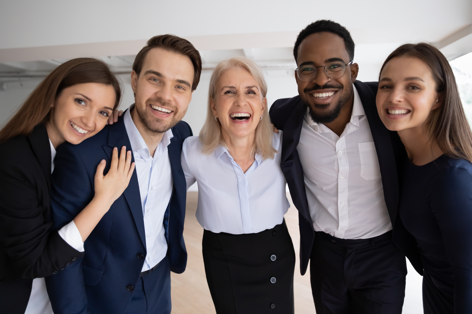 A group of business people are posing for a picture together.