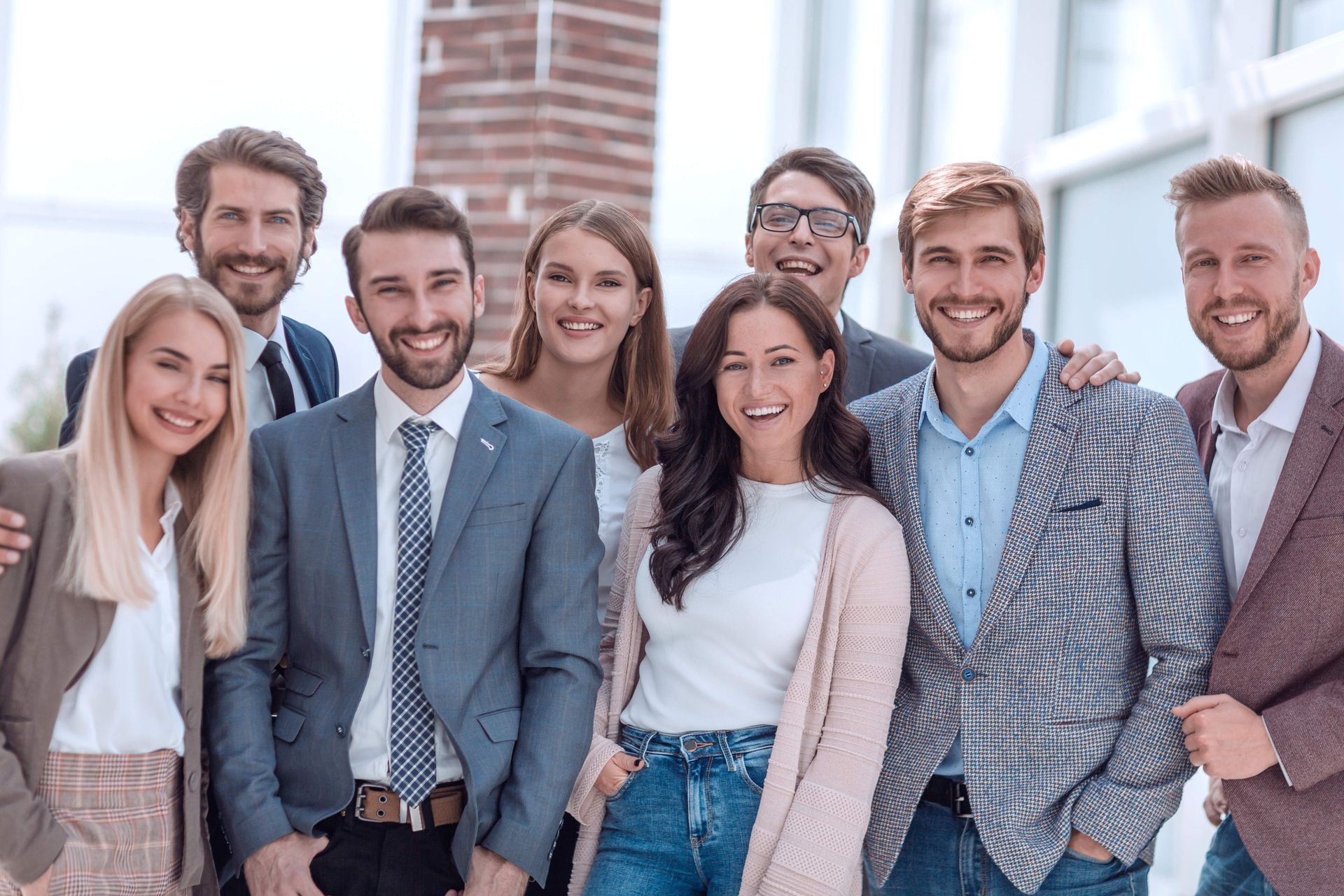 A group of people are posing for a picture together and smiling.