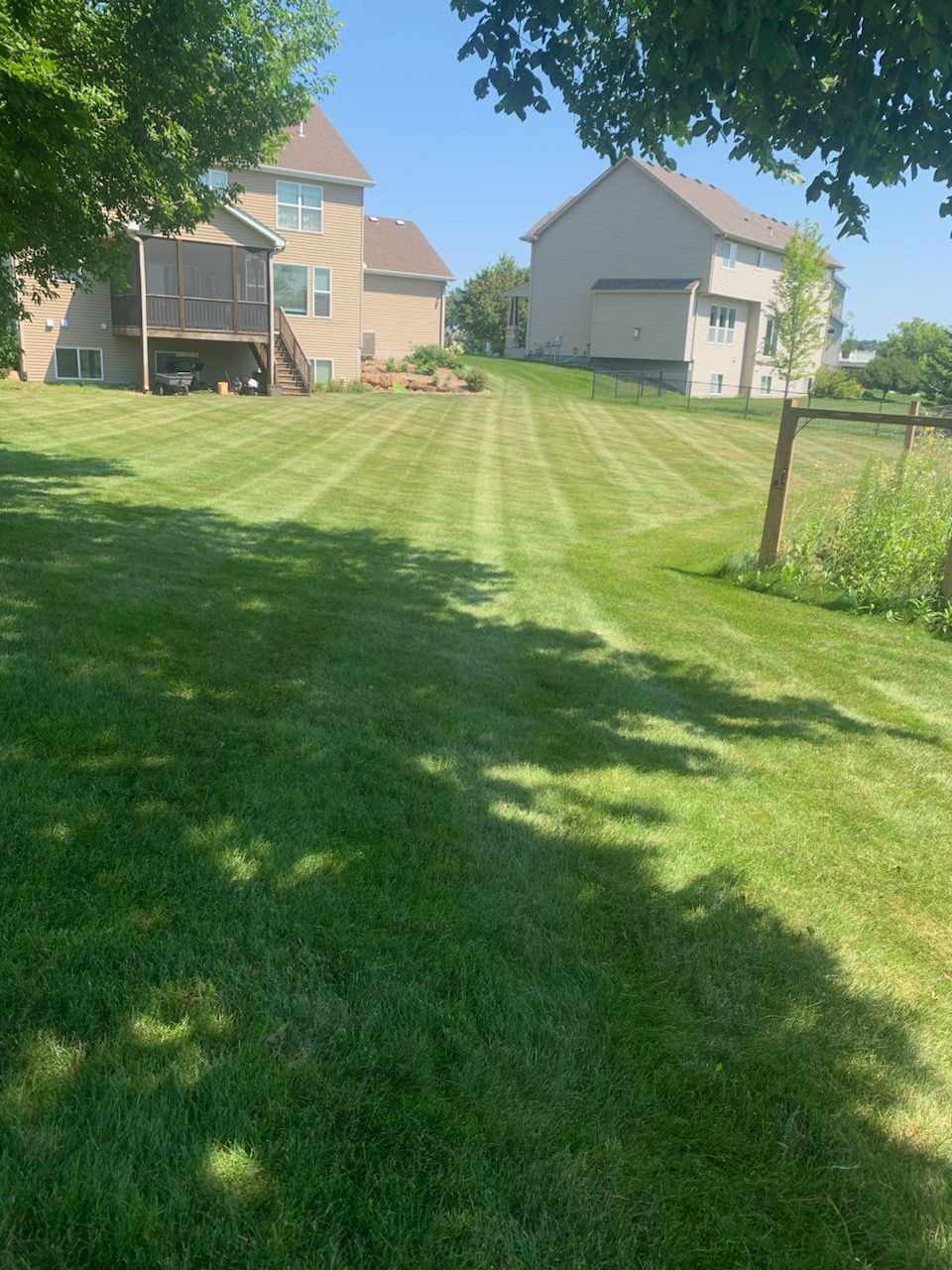 A man is using a lawn mower to cut the grass.