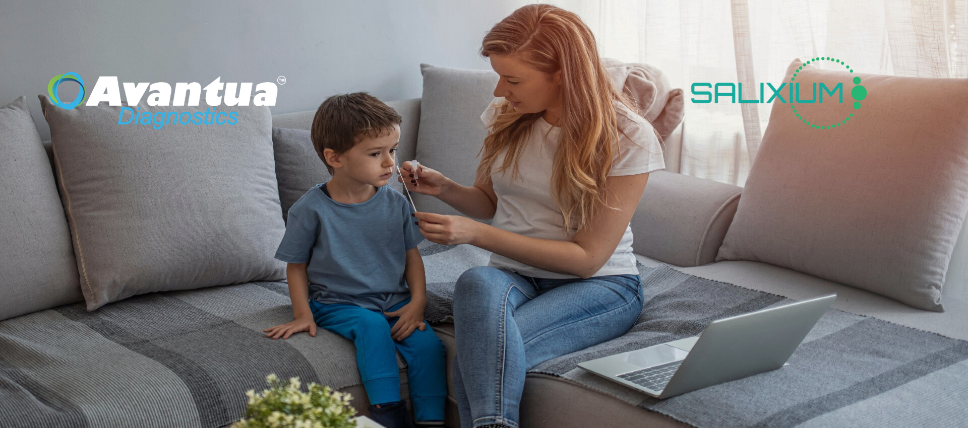 A woman is sitting on a couch with a child 