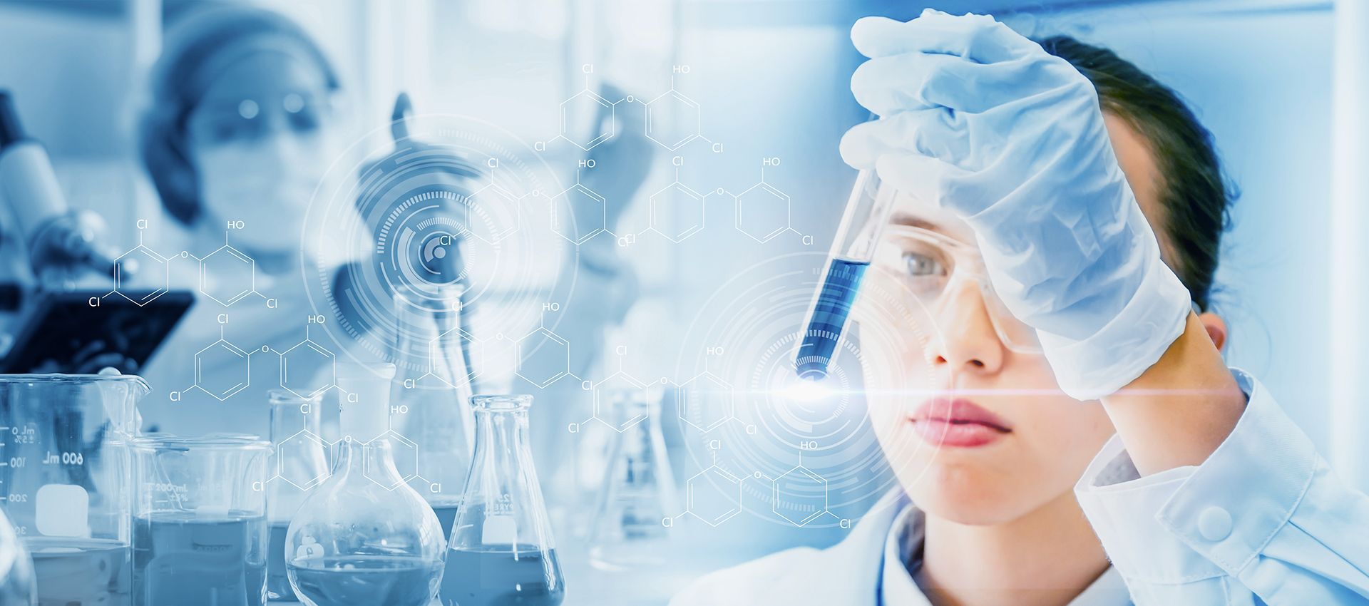 A female scientist is looking at a test tube in a laboratory.