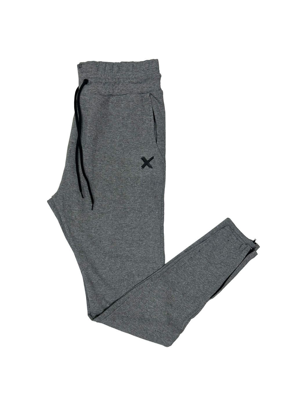 Un par de pantalones deportivos grises con una x negra en el lateral.