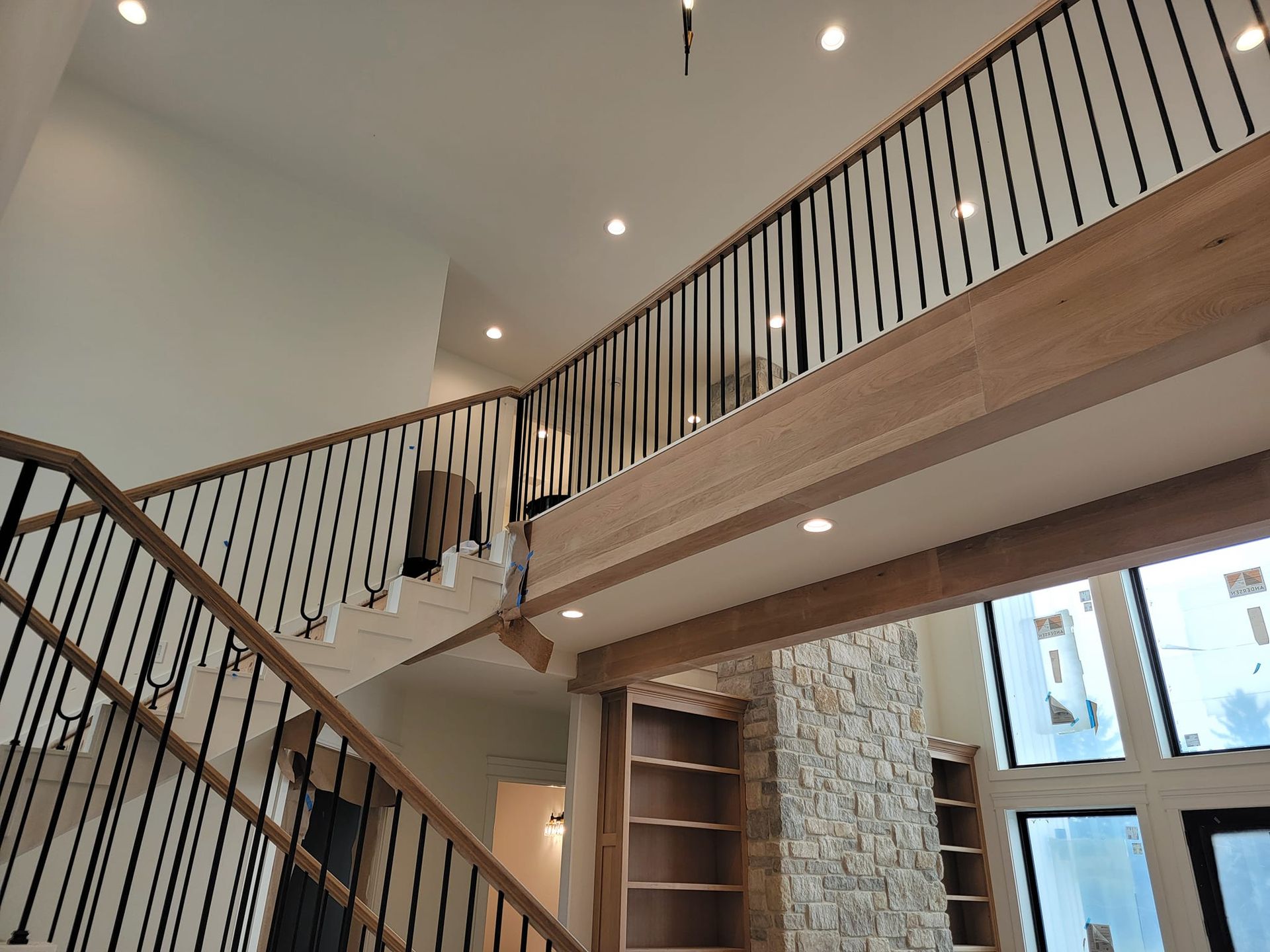 A wooden staircase with a metal railing in a house.