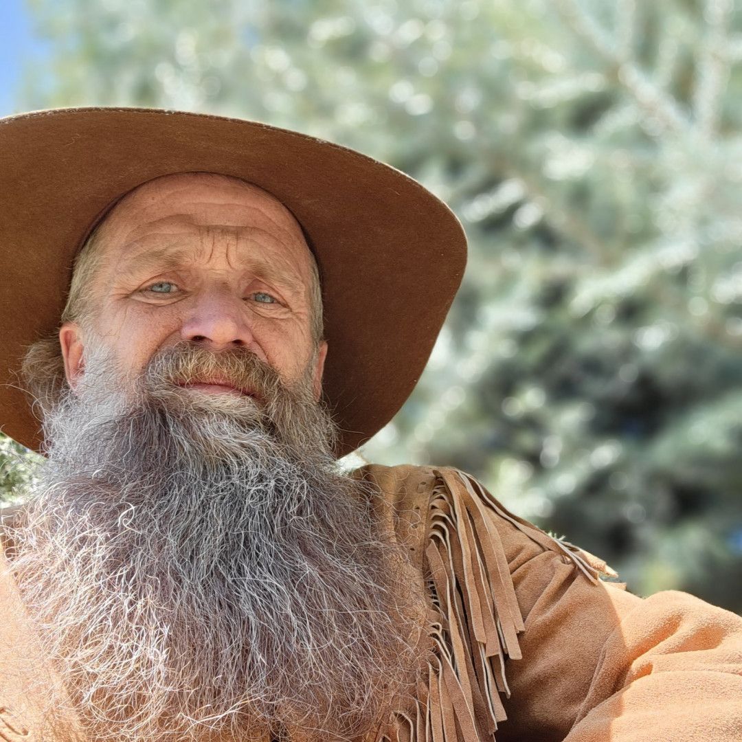 A man with a long beard wearing a hat