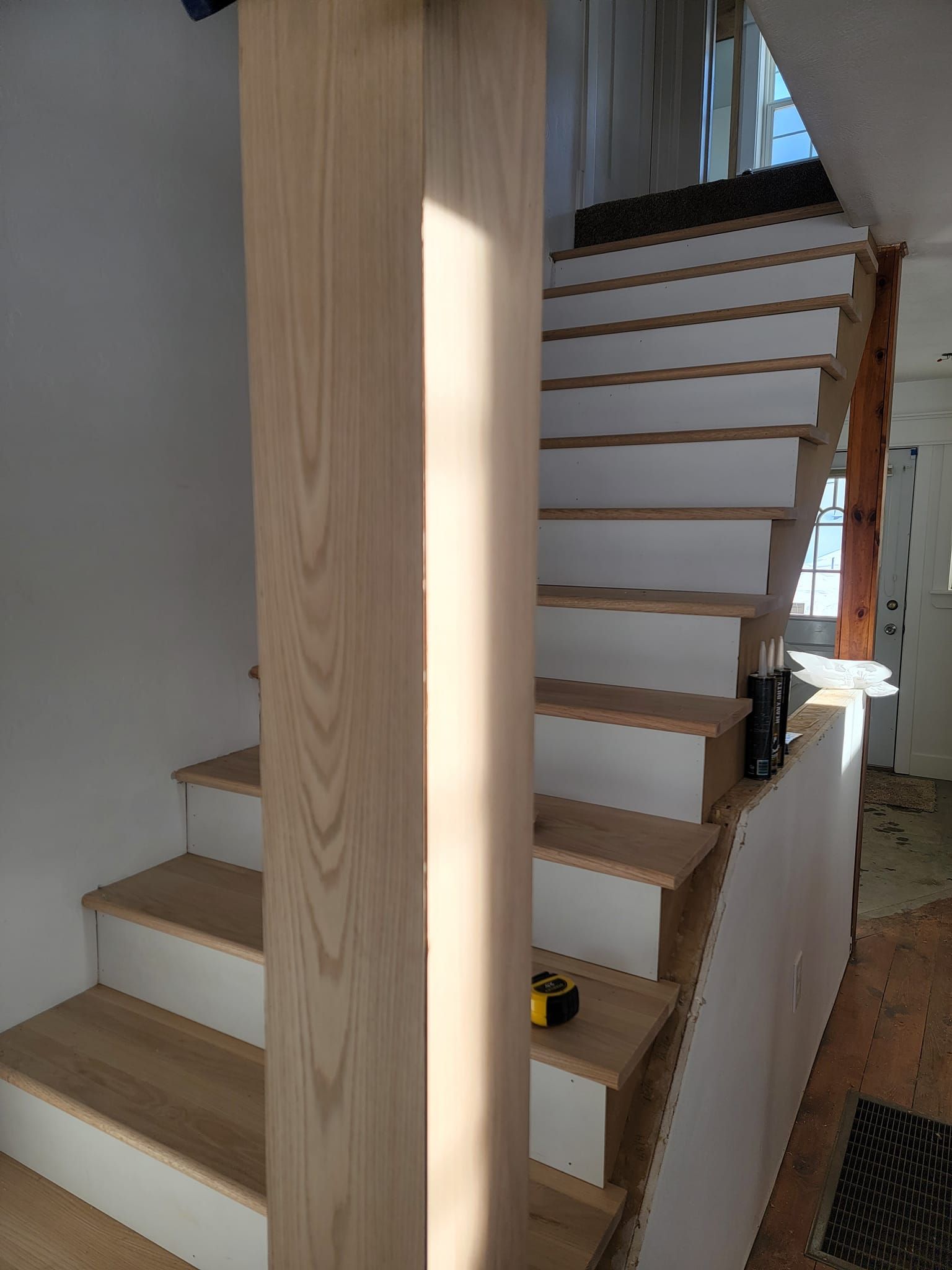 A staircase with white steps and wooden steps