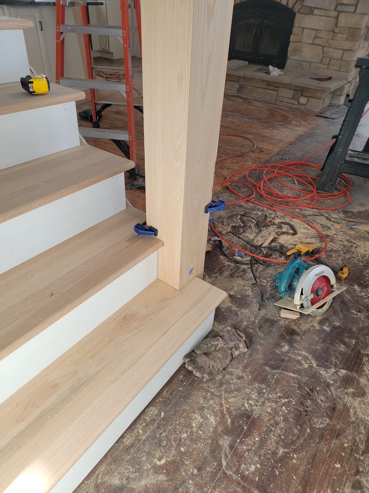 A wooden staircase is being built in a house.