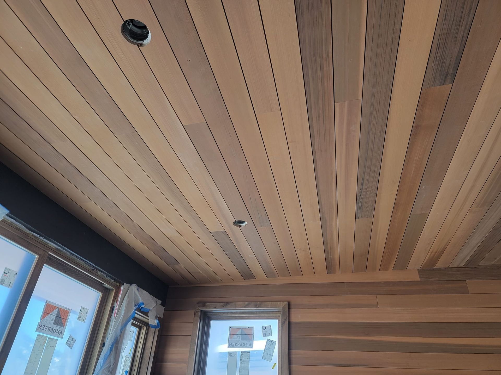 A room with a wooden ceiling and a window