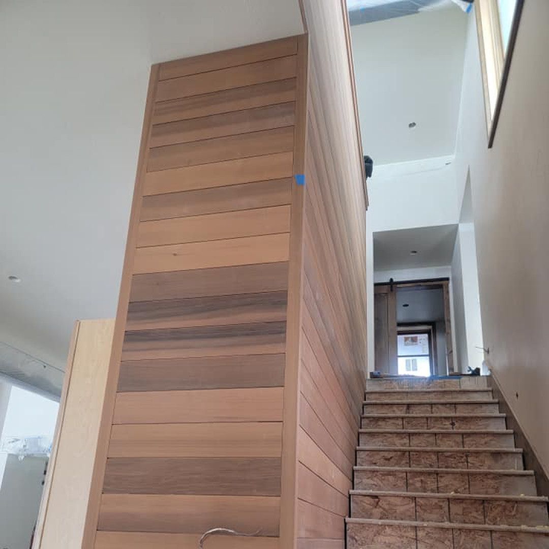 A set of stairs with a wooden wall behind them