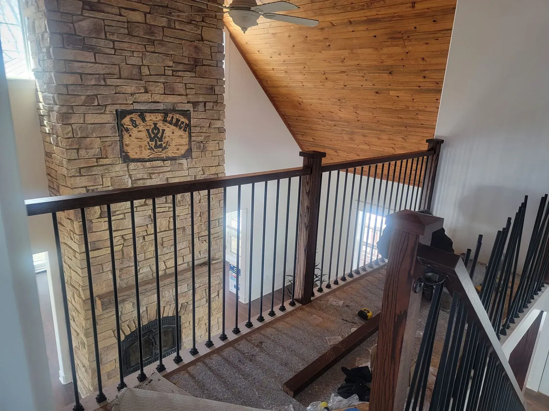 A view of a staircase from the second floor of a house.