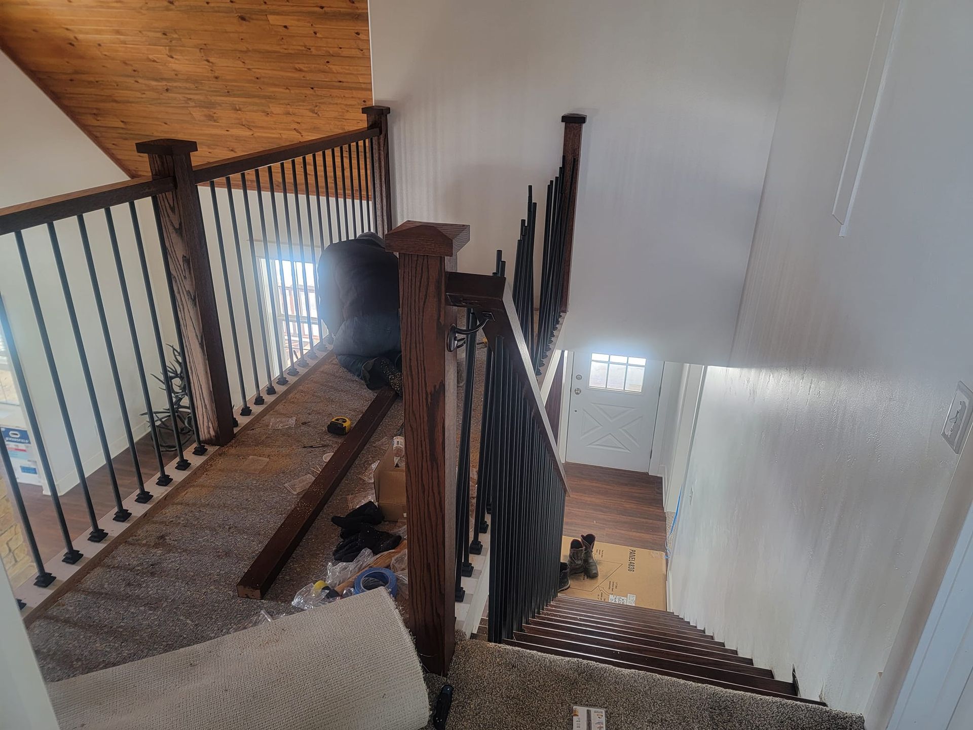 A view of a staircase from the second floor of a house.