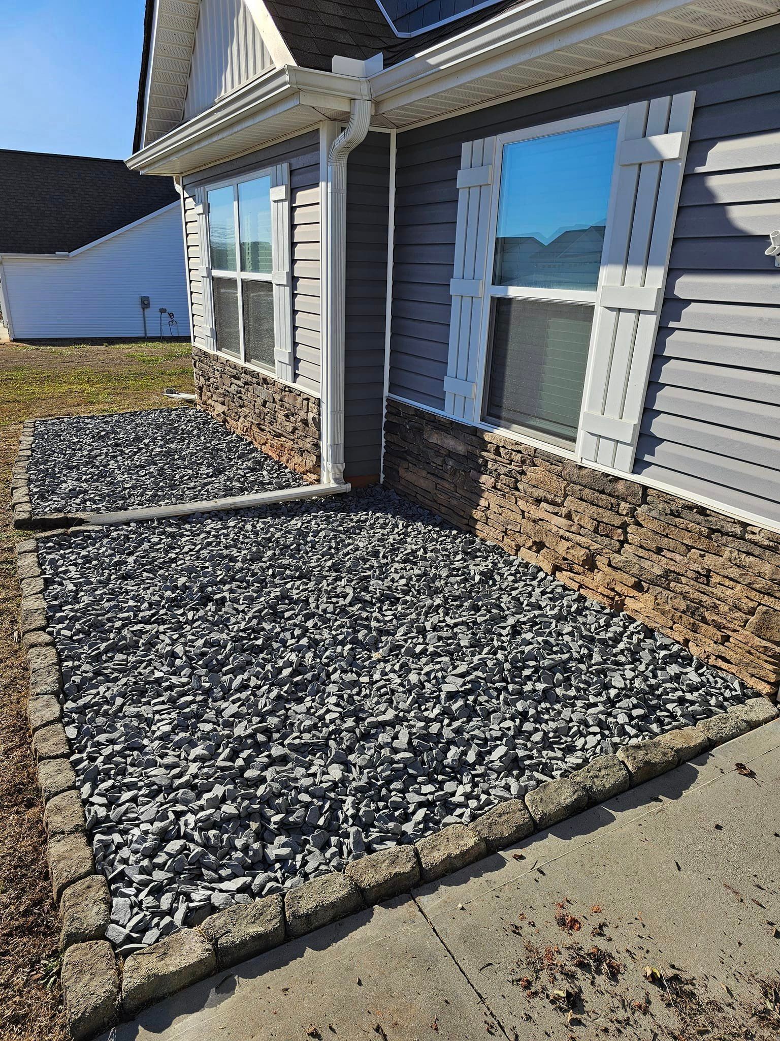 A house with a lot of gravel in front of it spartanburg 
