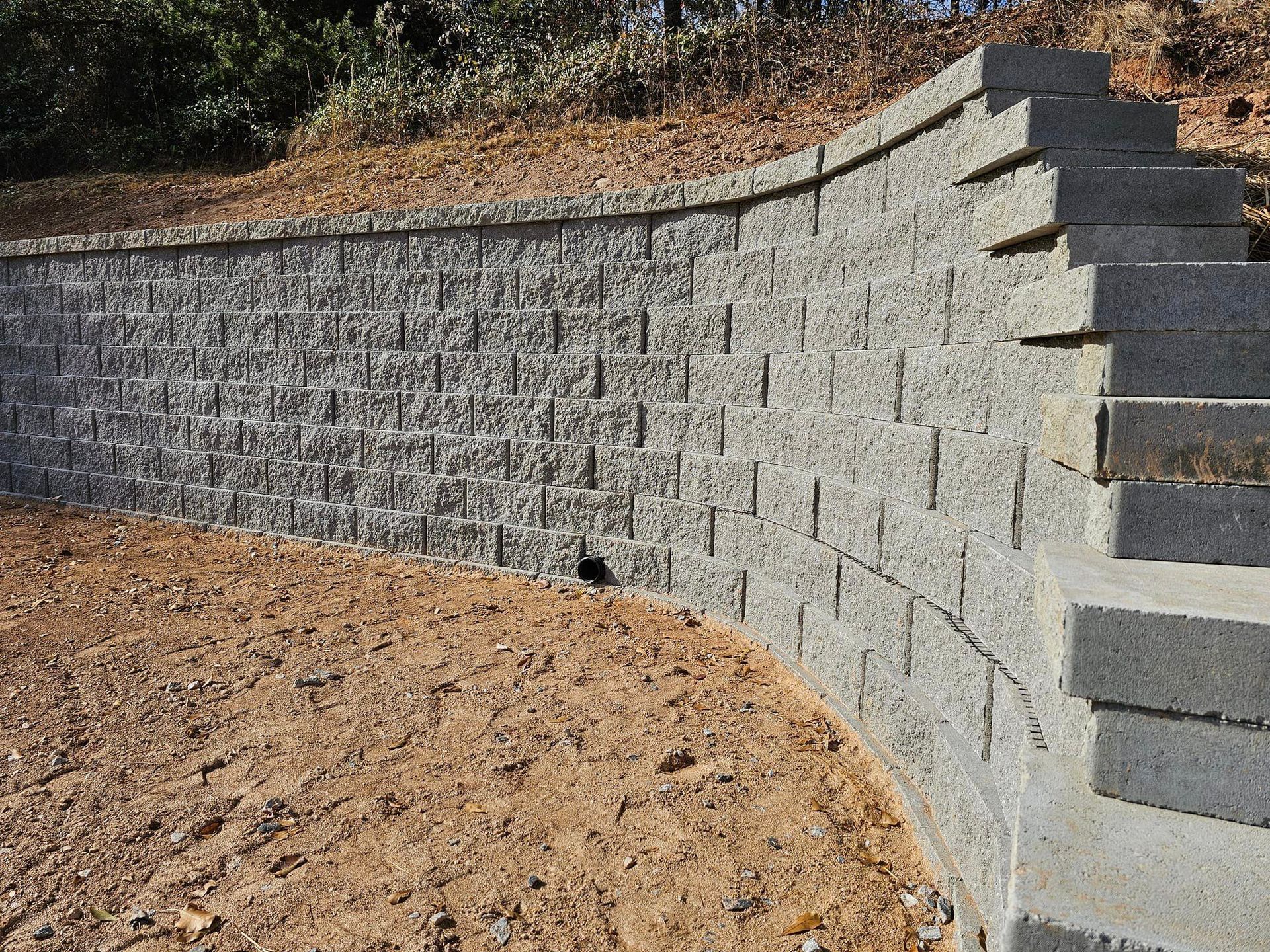 A brick wall is sitting on top of a dirt hill boiling springs 