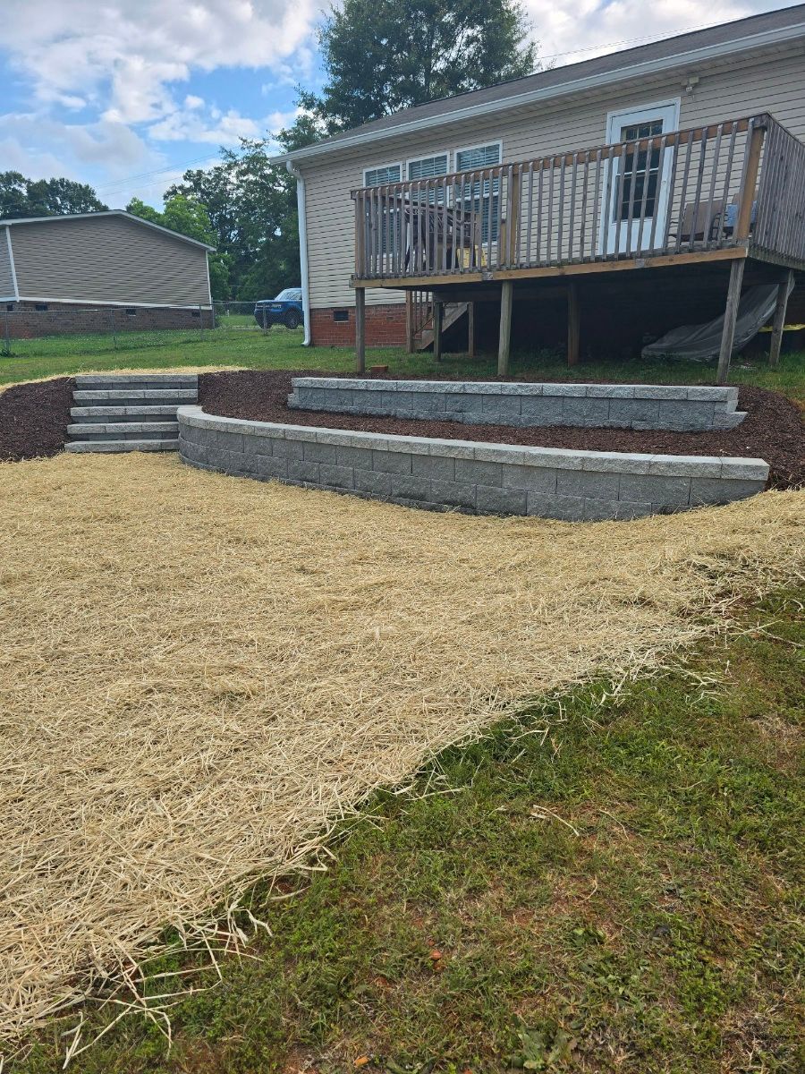 A house with a deck and stairs in front of it.