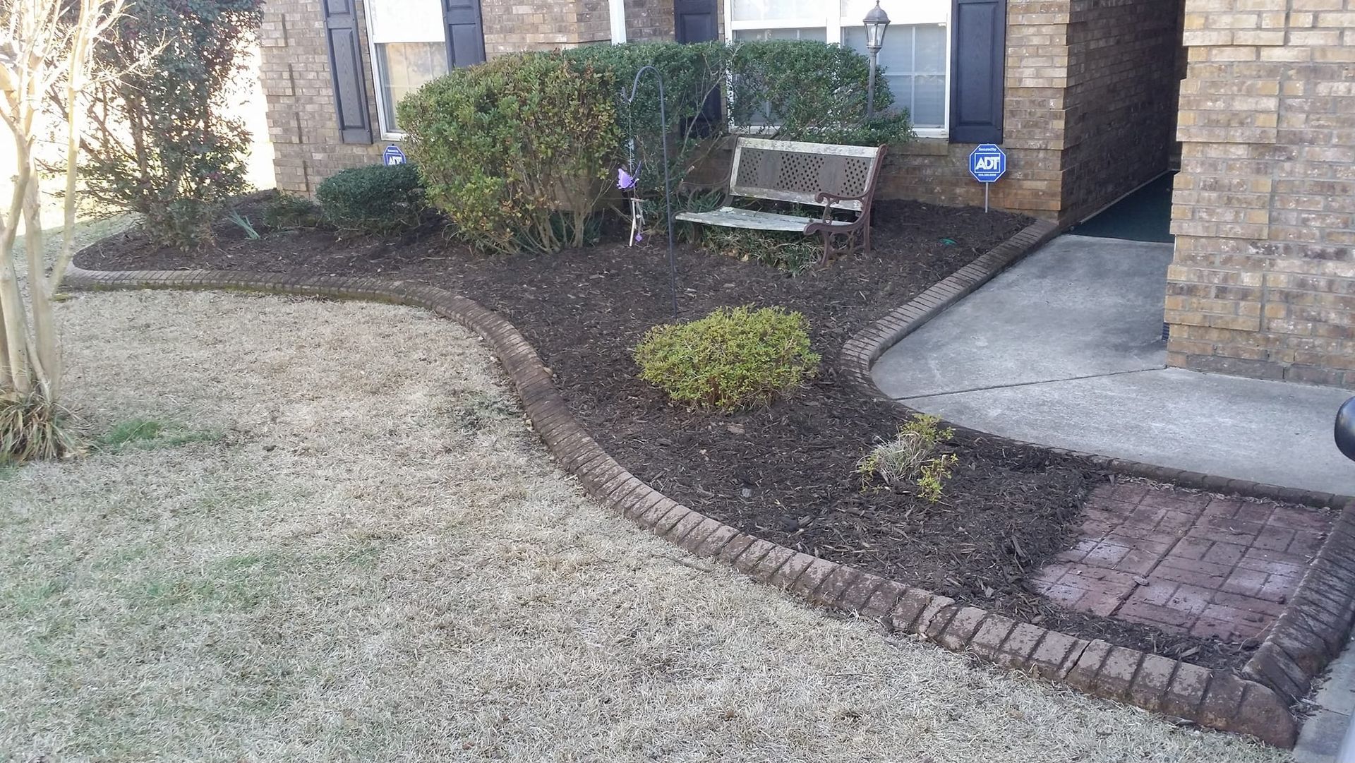 A brick house with a bench in front of it lyman 