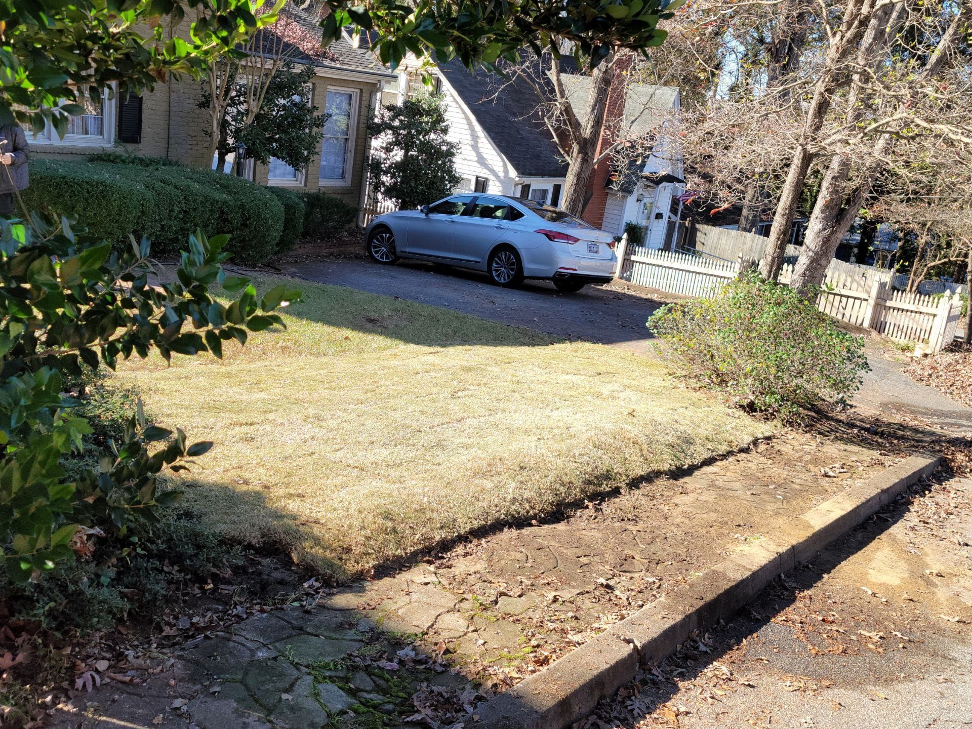 A silver car is parked in the driveway of a house. inman mills 