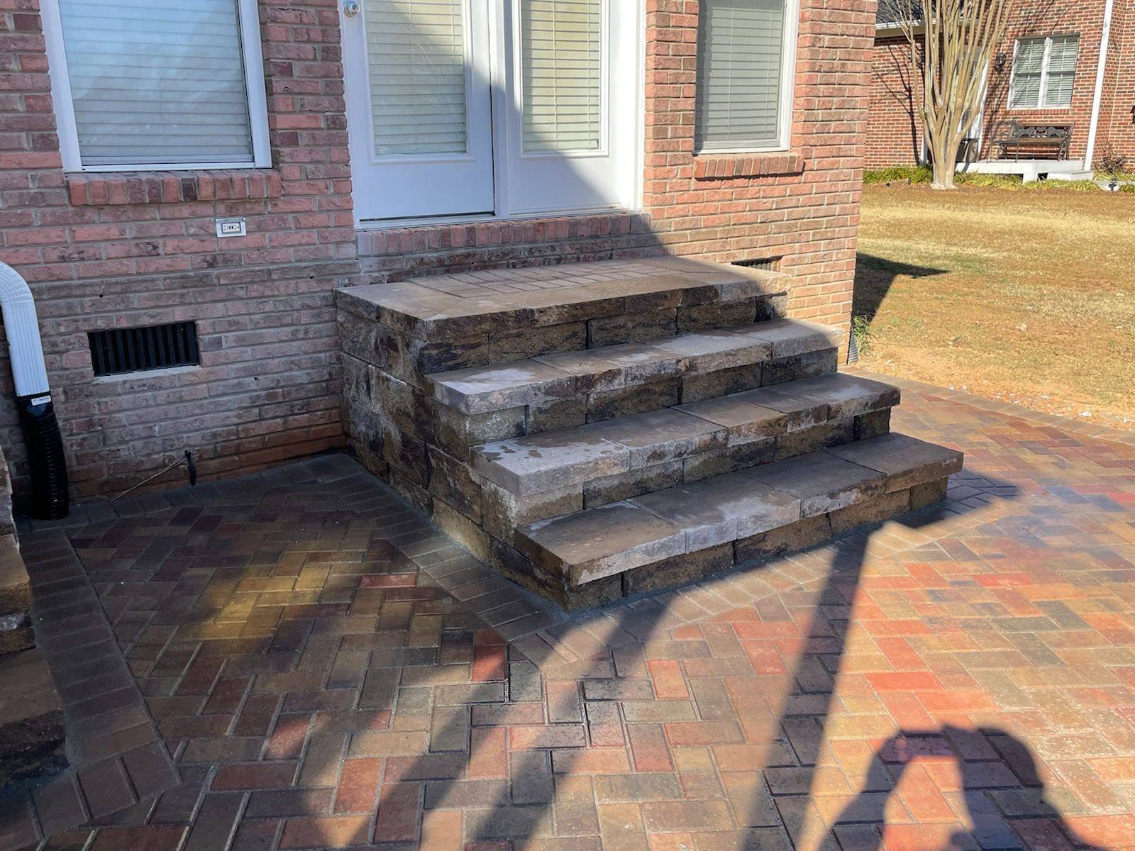 A set of stairs leading up to a brick house.
