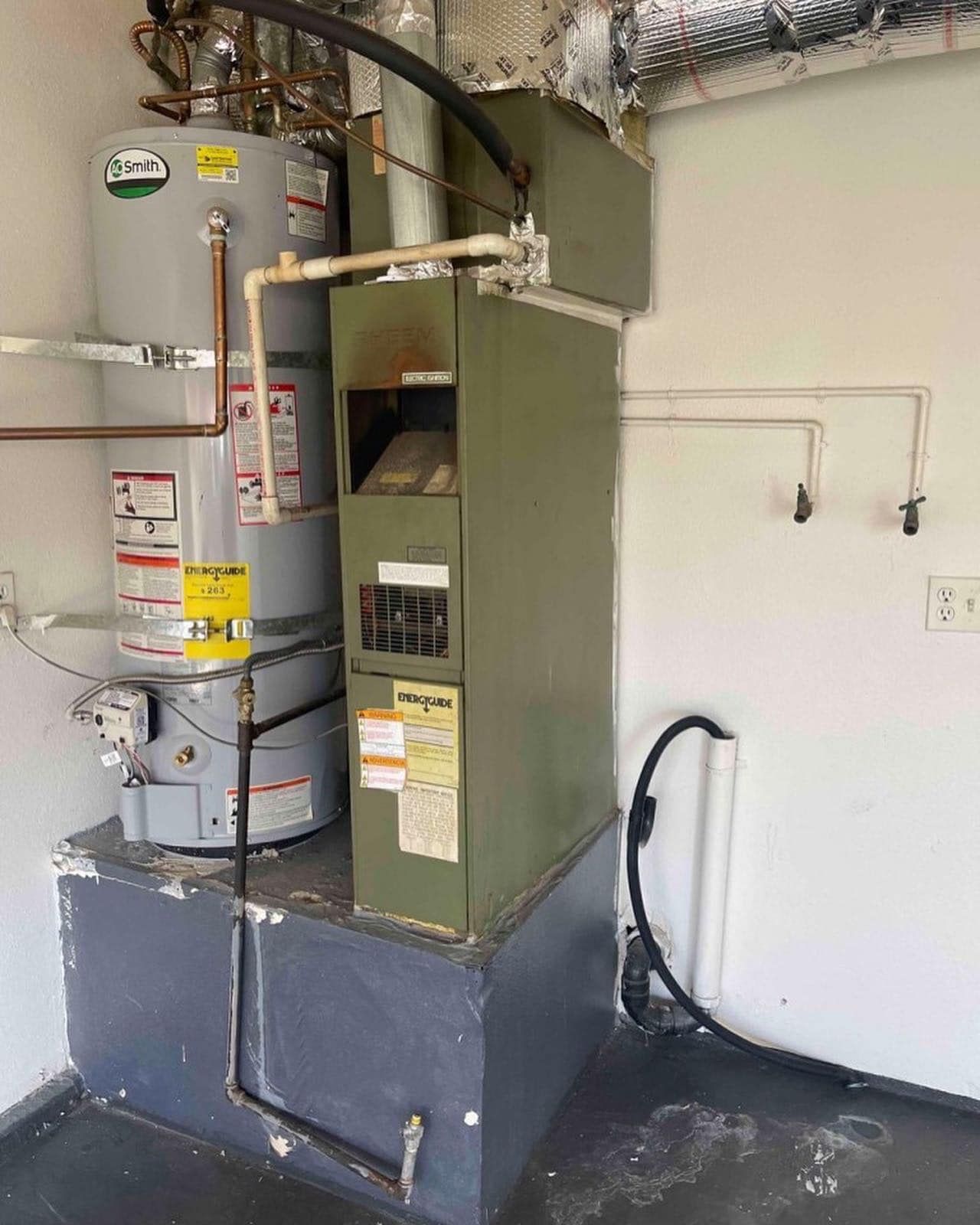 There is a water heater and an air conditioner in the room.