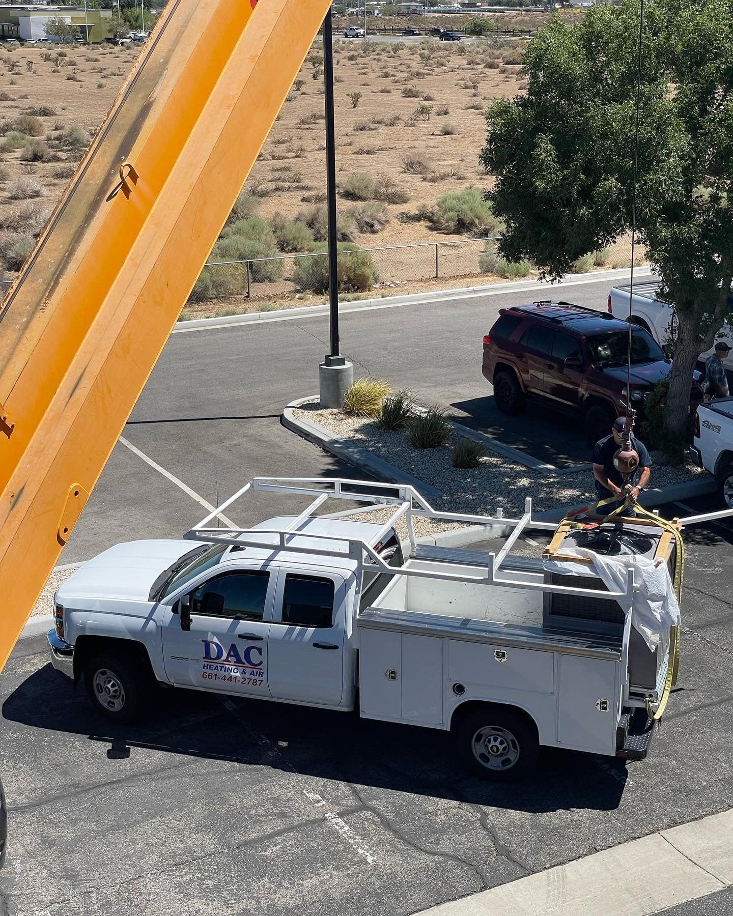A white truck with the word dac on the side is parked in a parking lot.