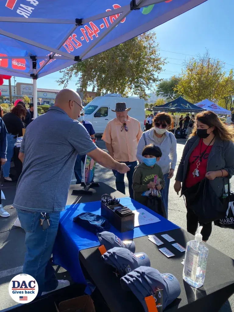 A man is shaking hands with a group of people at a table.