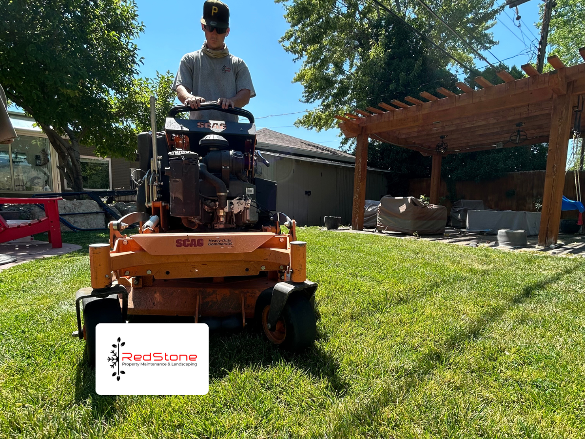 Professional lawn mowing service in Bountiful Utah with commercial mower on residential property