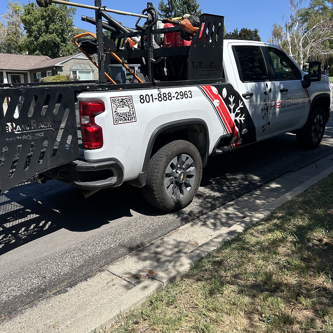 A white truck is parked on the side of the road.