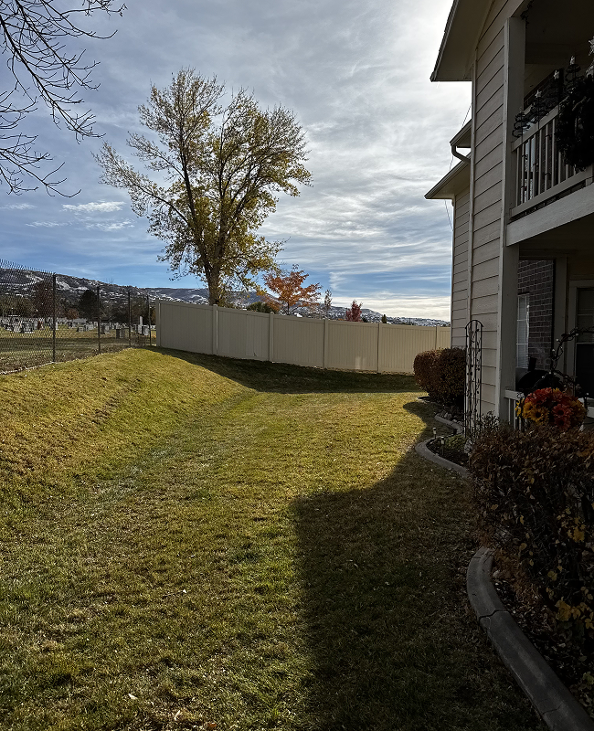 A row of apartment buildings with mountains in the background