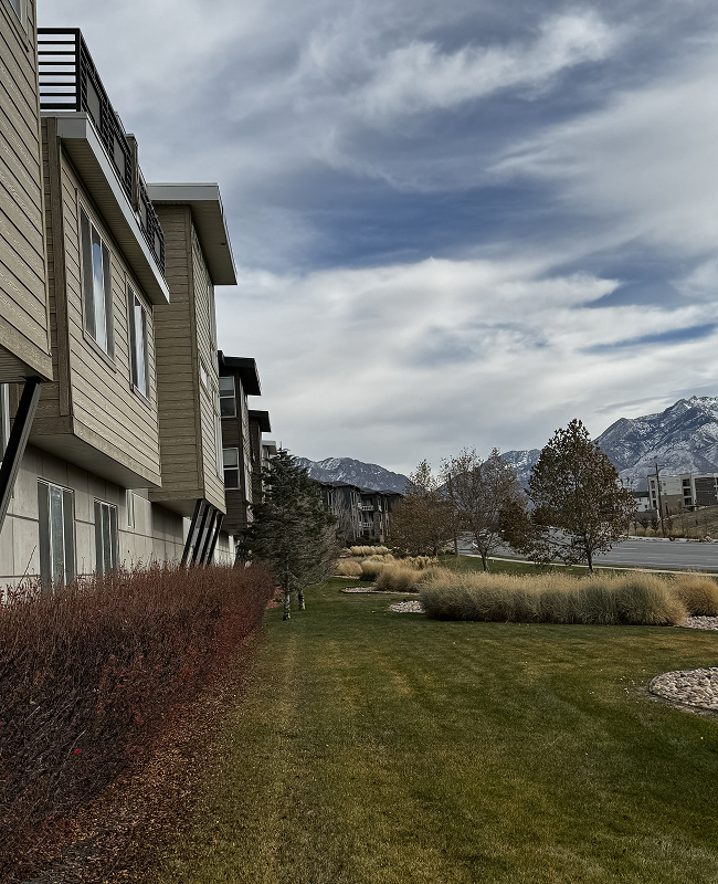 A row of apartment buildings with mountains in the background