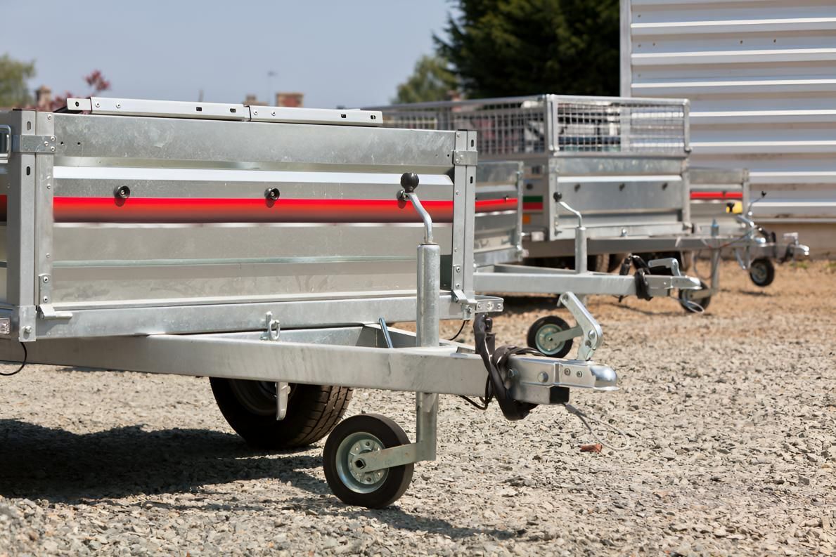 Row of Trailers Are Parked on Gravel in Front of a Building — SNS Custom Fabrication in Bundaberg East, QLD