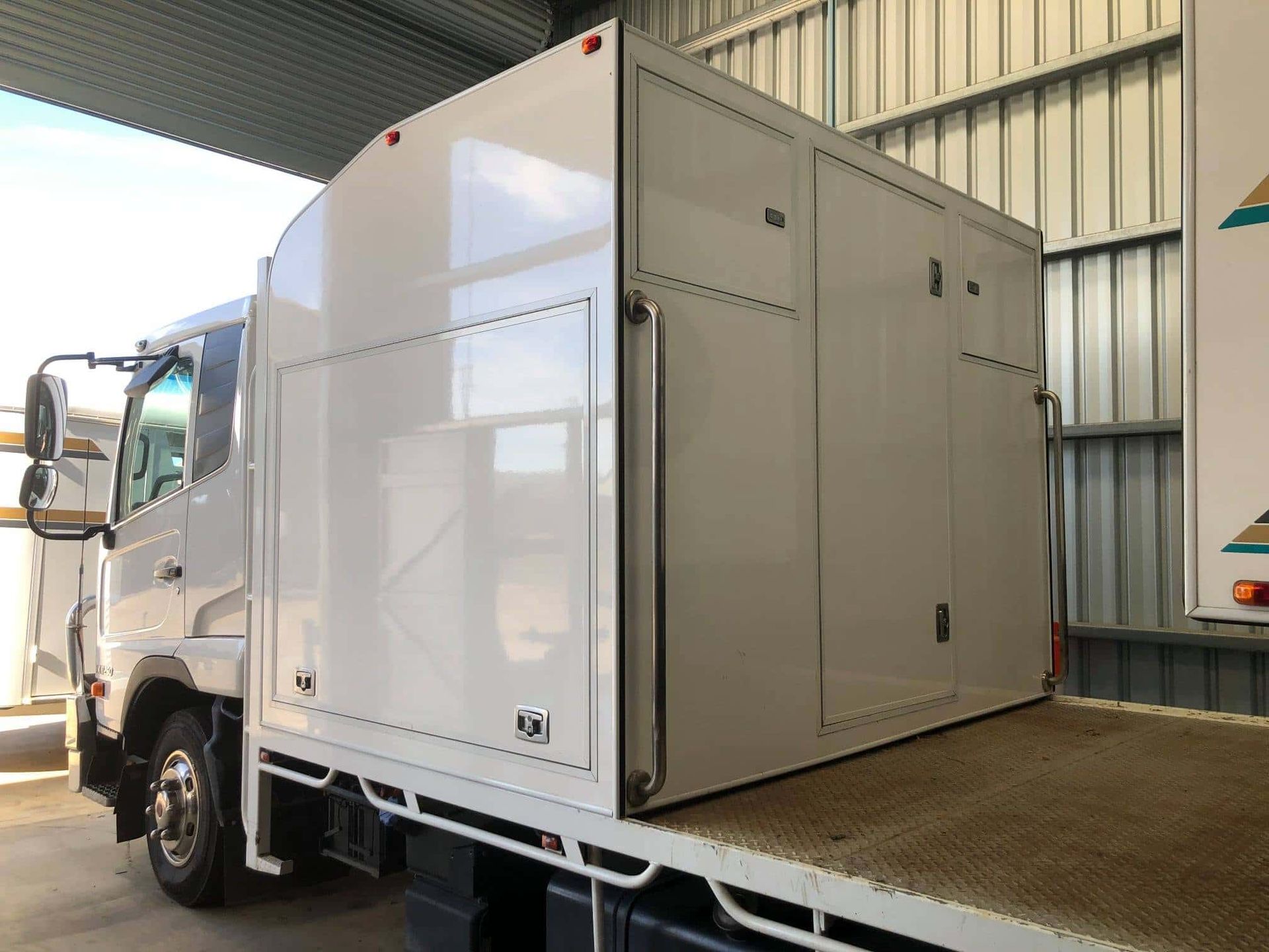 A white truck with a box on the back is parked in a garage. — SNS Custom Fabrication in Bundaberg East, QLD