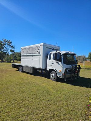 A White Truck is Parked in a Grassy Field — SNS Custom Fabrication in Bundaberg East, QLD