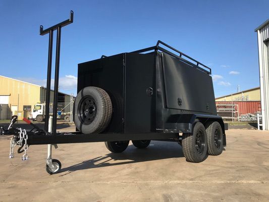 A Black Trailer With a Box on Top of It is Parked in a Parking Lot — SNS Custom Fabrication in Bundaberg East, QLD