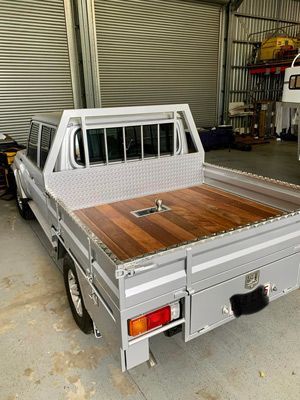 A Silver Truck With a Wooden Bed is Parked in a Garage — SNS Custom Fabrication in Bundaberg East, QLD