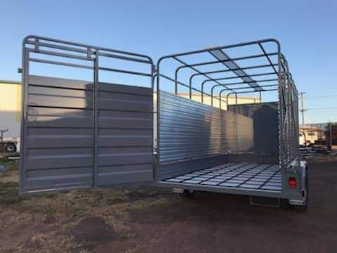 A Large Metal Trailer is Parked in a Dirt Lot in Front of a Building — SNS Custom Fabrication in Gladstone, QLD