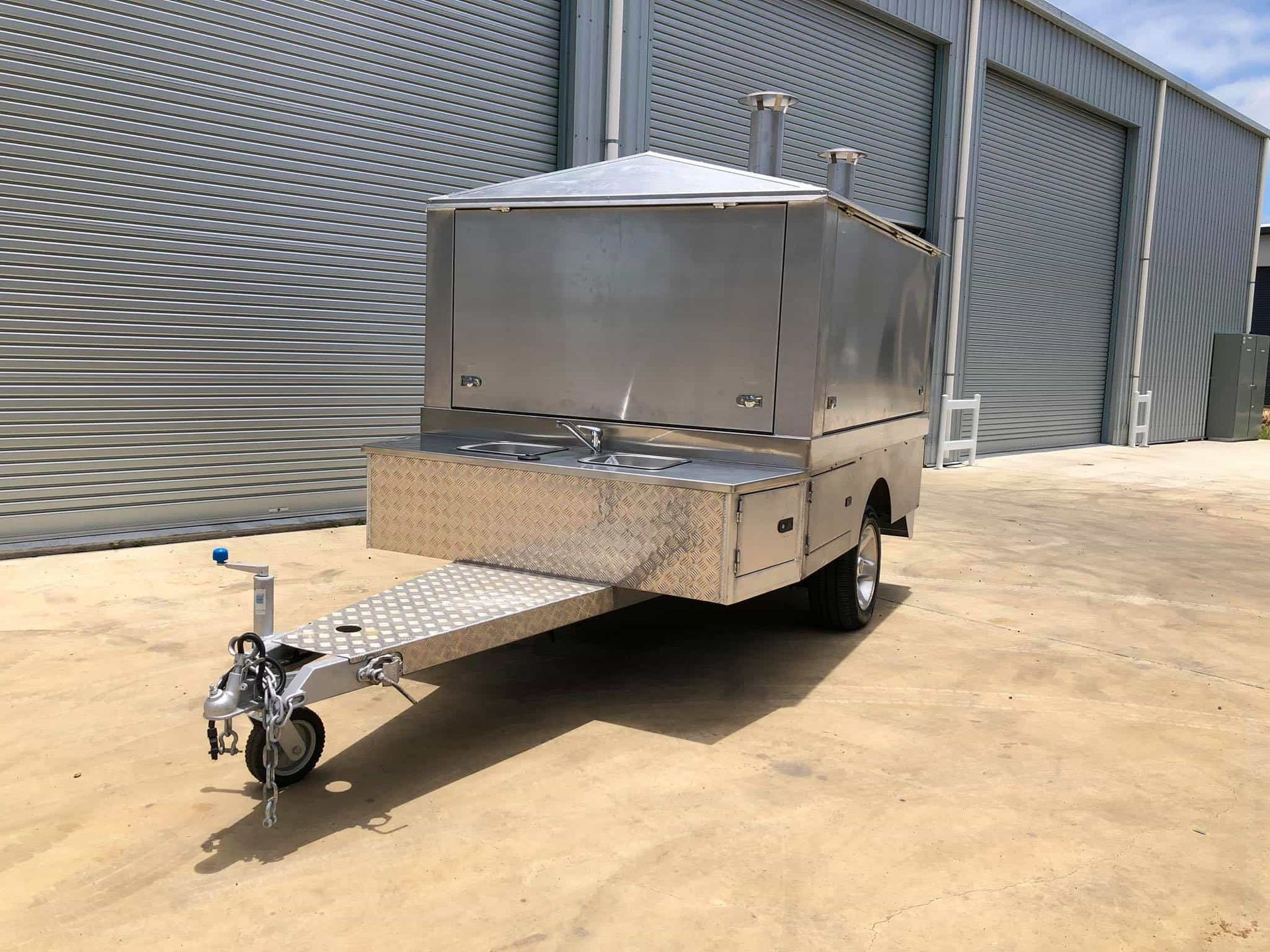 A stainless steel trailer is parked in front of a building. — SNS Custom Fabrication in Bundaberg East, QLD
