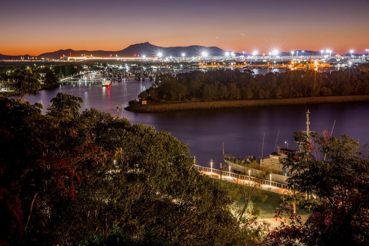 A View of a City From a Hill Overlooking a Body of Water at Night — SNS Custom Fabrication in Gladstone, QLD