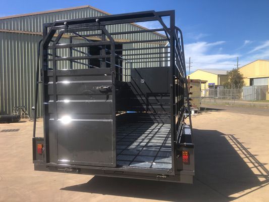 A Black Trailer is Parked in Front of a Building — SNS Custom Fabrication in Bundaberg East, QLD