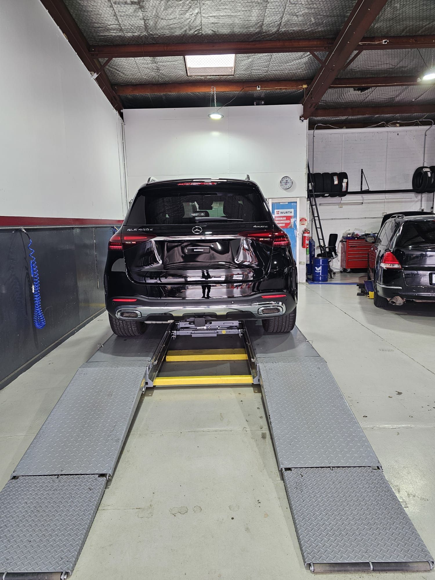 A Black Car Is Parked In A Garage — Capital Automotive Service in Fyshwick, ACT