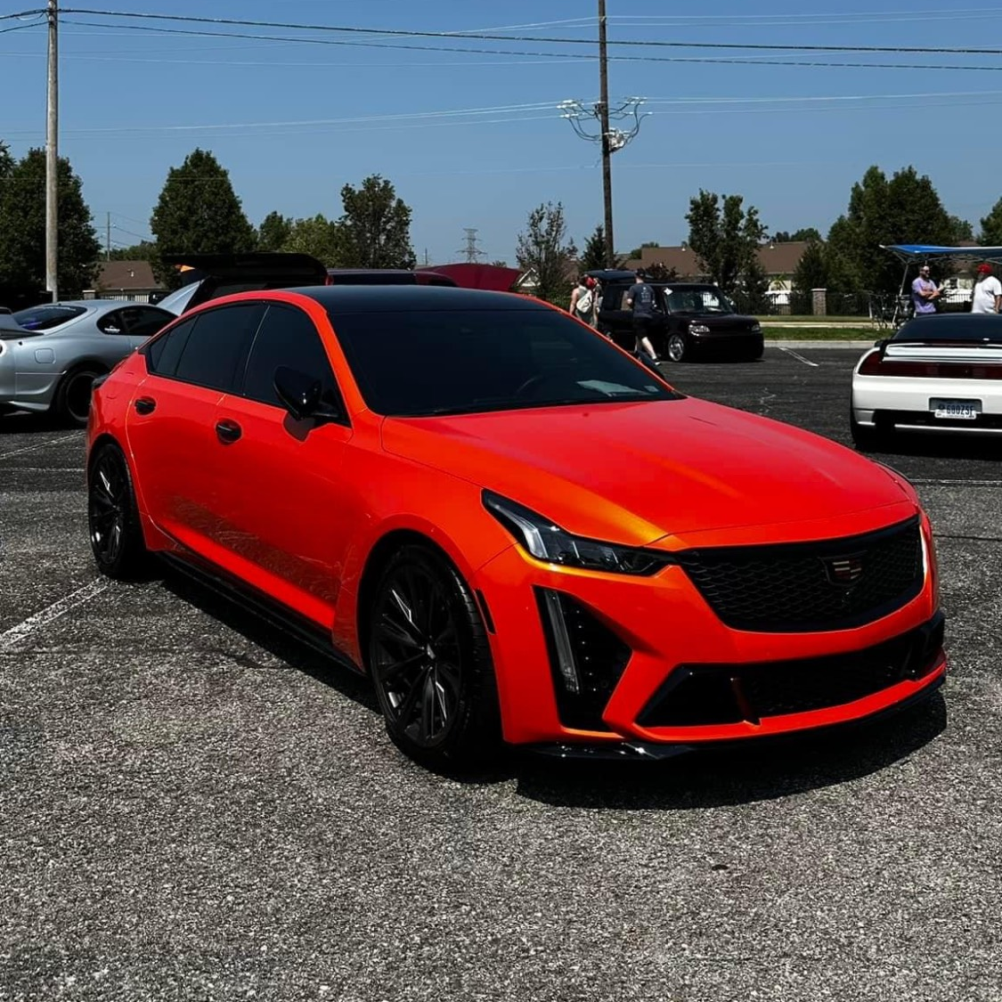 A red car is parked in a parking lot
