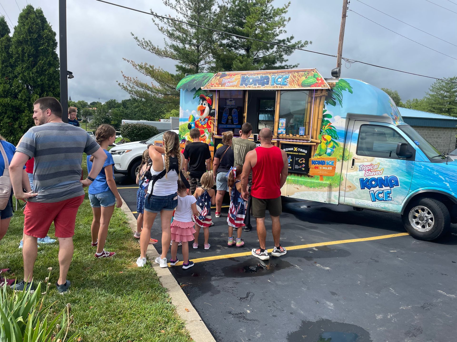 A group of people are standing in front of a food truck.