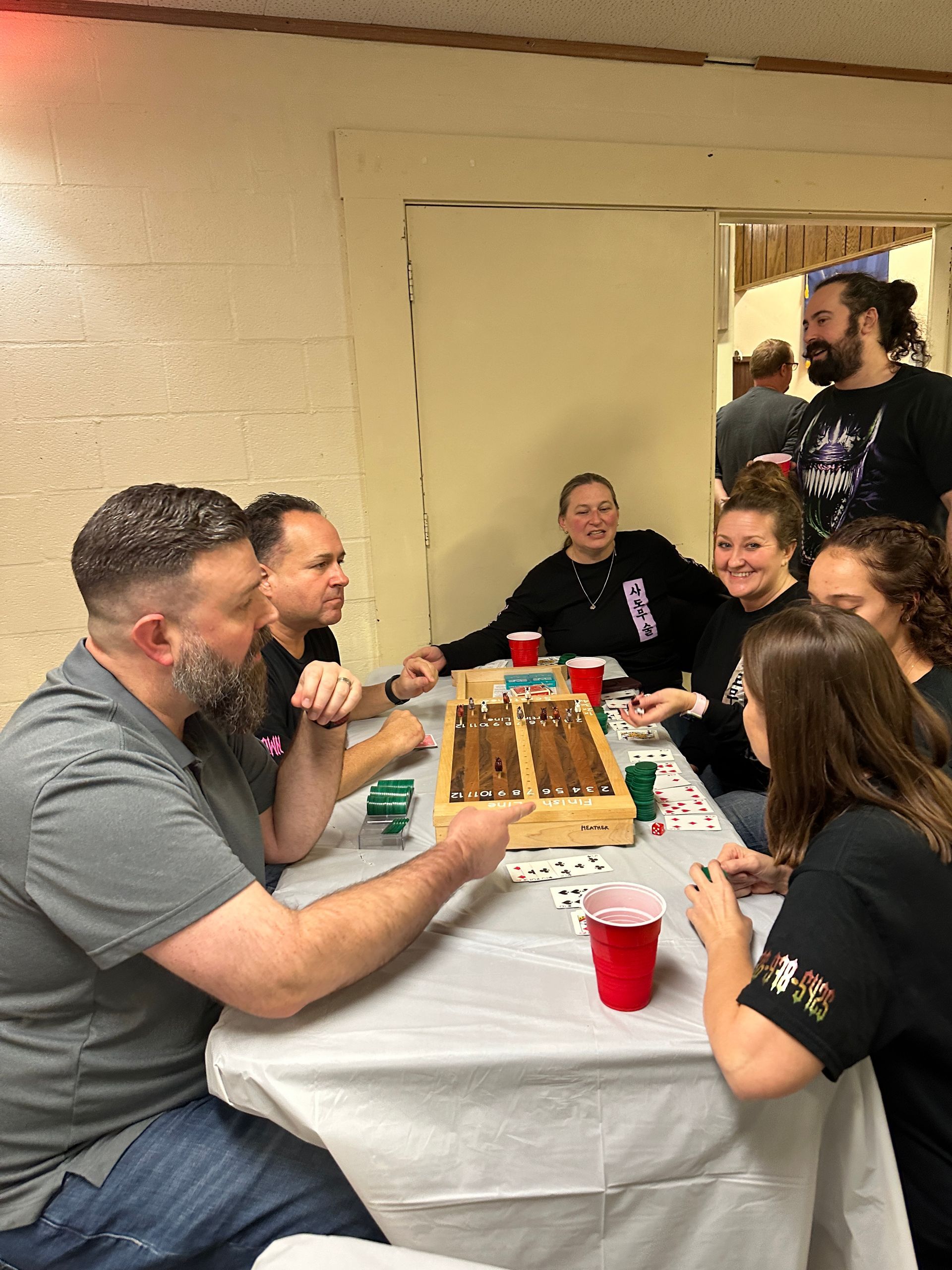A group of people are sitting at a table playing a game.